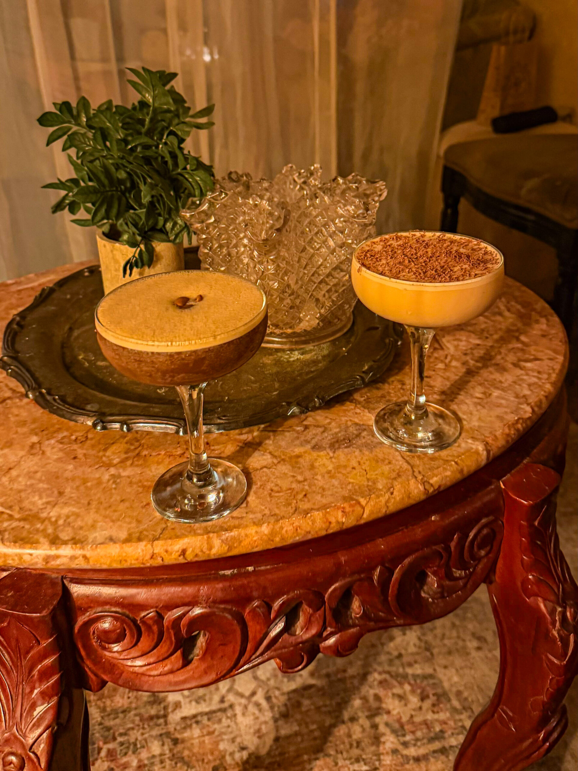 Espresso martini and tiramisu martini on a marble table at Scotty Doesn't Know speakeasy in Charleston